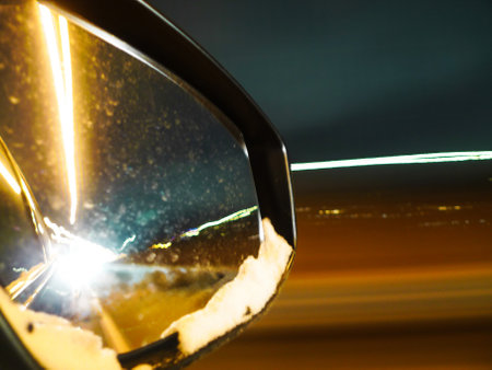 car mirror on the road in the city at night with motion blurの写真素材