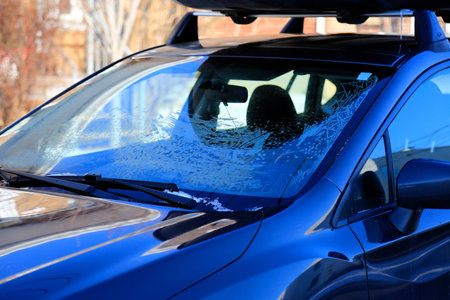 Blue car with frosted glass in winter