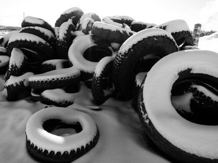 Tires covered with snow in winter. Black and white photo.の写真素材