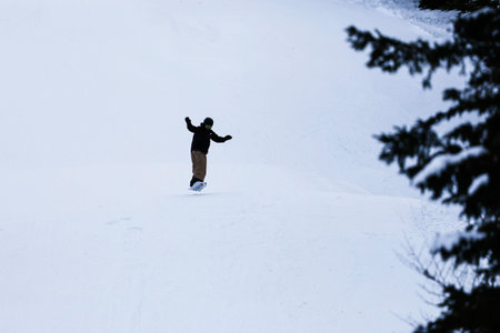 Snowboarder on the snow in the mountains. Extreme winter sport.のeditorial素材