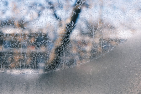 Frosty patterns on the window glass. Abstract winter background.