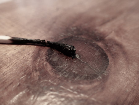 Burnt match on a wooden surface. Selective focus. Toned.の写真素材