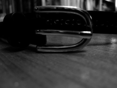 Black belt on a wooden table. Black and white photos. Selective focus.の写真素材