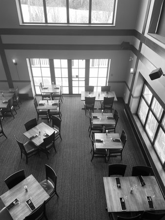 Interior of a restaurant with tables and chairs in black and white