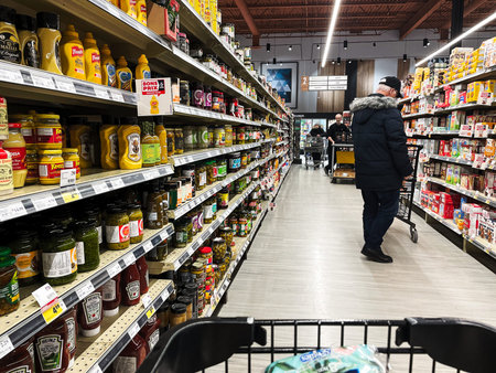 A man shopping for food products in a supermarket.のeditorial素材