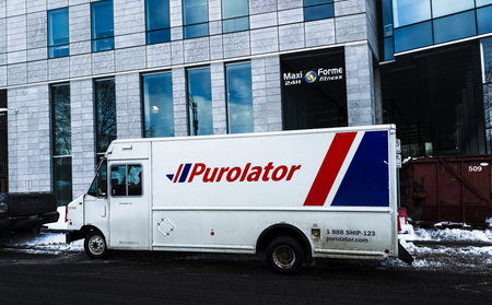 A Purolator delivery truck on the street in Quebec city in winter.のeditorial素材