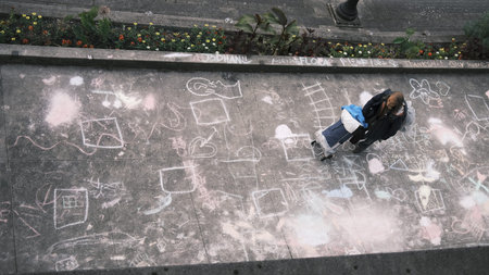 Top view of a homeless person in the city of Vancouver. With chalk drawings on the floor.