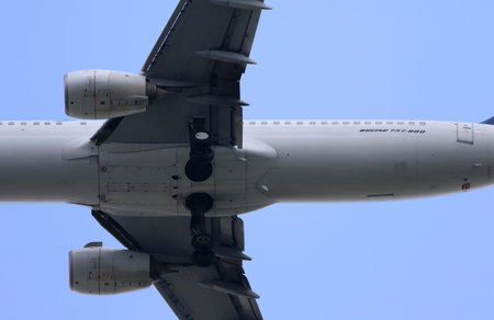 Boeing 737-800. Airplane in the blue sky, close-up of the wing