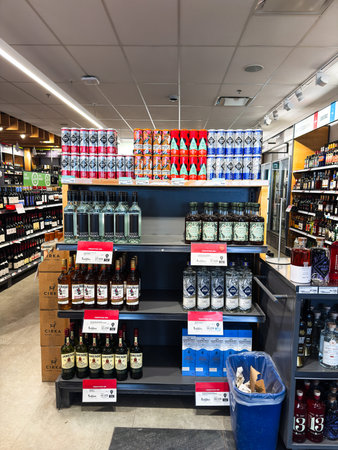 Shelves with different alcoholic beverages in a SAQ in Quebec.のeditorial素材