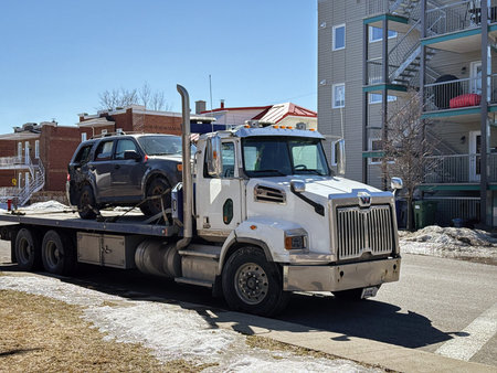 A tow truck transports a broken car in Quebec city, Quebec, Canada.