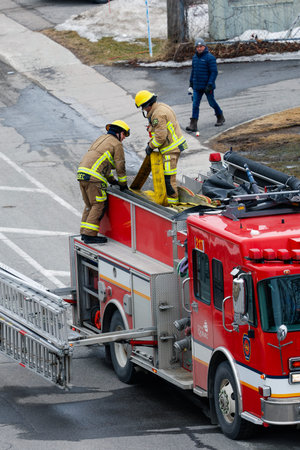 Firefighters extinguish a fire on a road in the Quebec city. Quebec City firefighters on call for a...