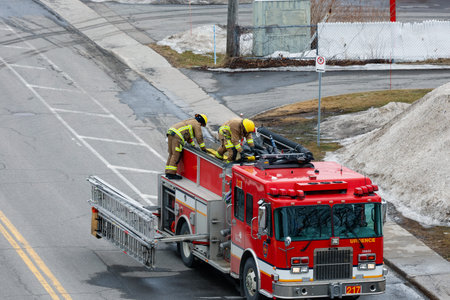 Firefighters extinguish a fire on a road in the Quebec city. Quebec City firefighters on call for a...