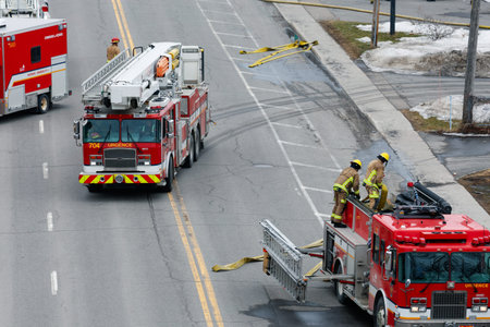 Firefighters and emergency vehicles on the road in Quebec city. Quebec City firefighters on call for...