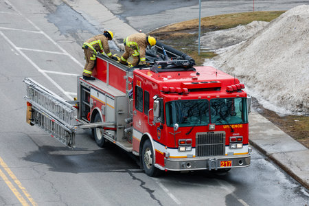 Firefighters extinguish a fire on a road in the Quebec city. Quebec City firefighters on call for a...