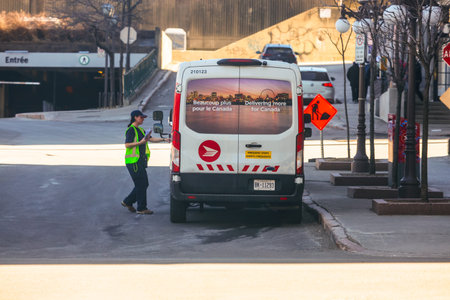 A Canada Post truck and a mail carrier in Quebec City