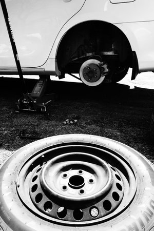 Changing a car wheel. Black and white photos. Car maintenance.