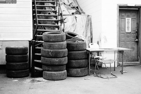 Pile of tires in front of the garage, black and white. Black and white.の写真素材