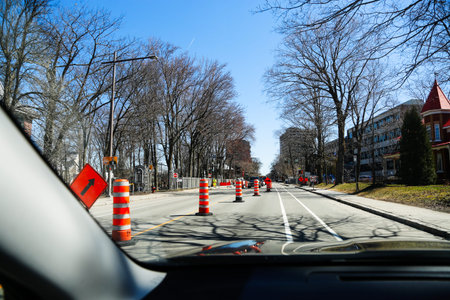 Quebec, Canada. A street under construction with red barriers in Quebec City. Traffic cones on the...
