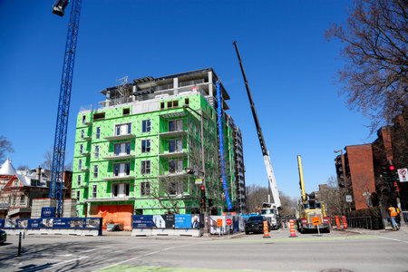 Construction of a multi-storey residential building. Tower crane and building under construction on...