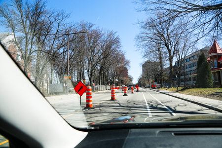 Quebec, Canada. A street under construction with red barriers in Quebec City. Traffic cones on the...