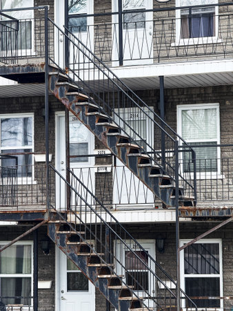 Old fashioned fire escape stairs on an old building in Quebec city.の写真素材