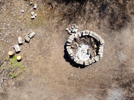 A fire pit in the forest while camping, top view