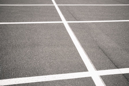 Empty parking lot with white line on asphalt, closeup of photo