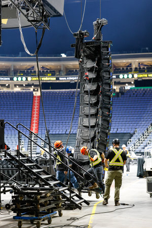 Technicians dismantle the stage and lighting after a show. Backstage view.のeditorial素材