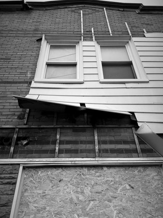 A view of the facade of an abandoned and dilapidated building.