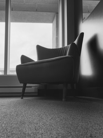 Black and white image of an armchair in a waiting room.の写真素材