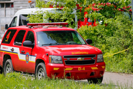 Firefighters and emergency vehicles at a training site.
