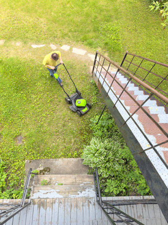 Aerial view of a man mowing the lawn.