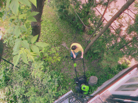 Aerial view of a man mowing the lawn.の写真素材