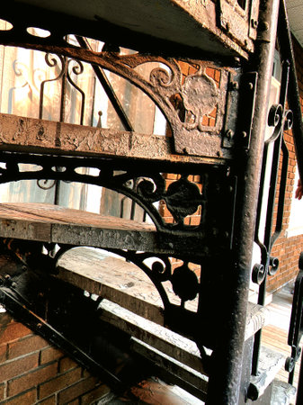 Old iron stairs in an old house, closeup of photo. Spiral staircase in front of a building.の写真素材