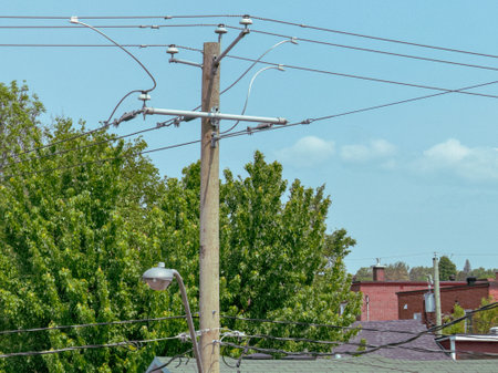 Electric pole with wires and cables in an urban areaの写真素材