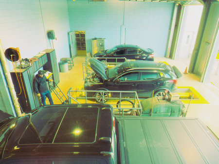 Auto mechanic repairing a car in a garage.のeditorial素材