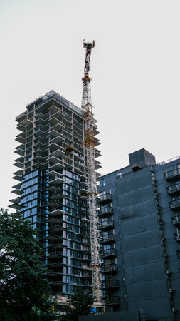 Construction site with tower crane and building under construction, Vancouver, Canada.の写真素材