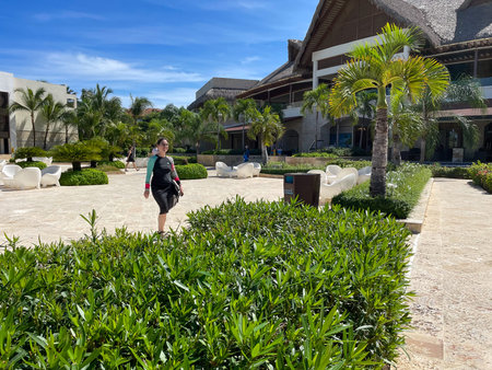 Woman walking in the garden of a luxury hotel. Luxury hotel in Punta Cana, Dominican Republic.のeditorial素材