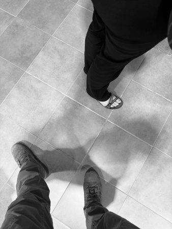 Feet in shoes on the floor. Black and white photos.