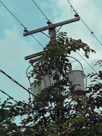 Power line with blue sky and white clouds in the background. Electricity distribution. Electric pole...