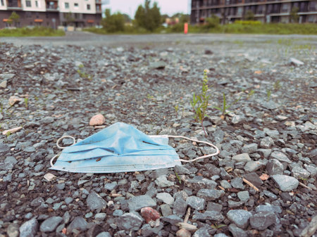 Surgical mask thrown on the ground. Environmental pollution. Selective focus.の写真素材