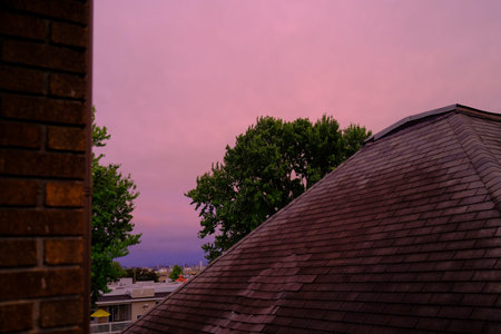 The roof of the house on a background of the sky with cloudsの写真素材