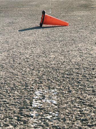 Traffic cone on the asphalt road. Close-up photo.