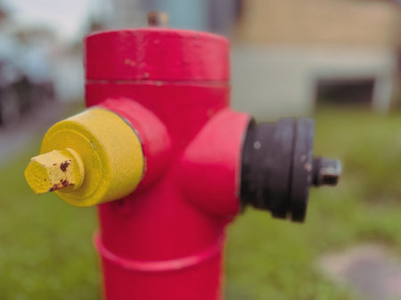 Red fire hydrant on the grass in the yard. Selective focus.
