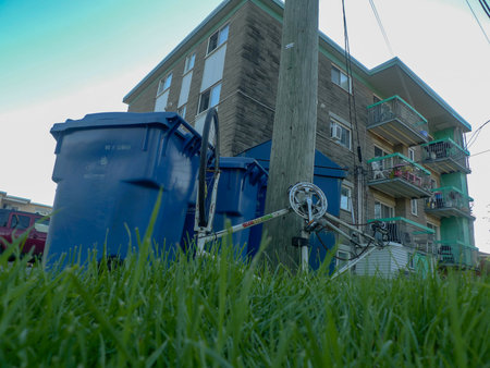recycling bin and old bicycle in front of a residential buildingのeditorial素材
