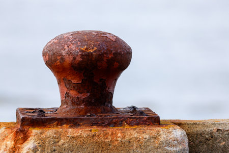 Old rusty bollard on the seashore. Selective focusの写真素材