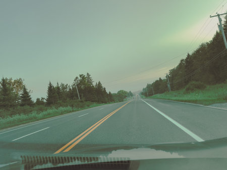 View from inside the car on the road with motion blur effect. View on the road in Charlevoix, Quebec, Canada.の写真素材