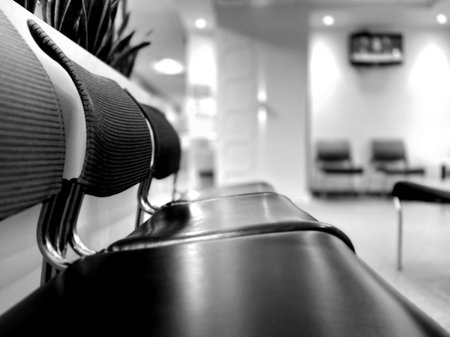 Black and white of chairs in the waiting room. Chairs in a clinic waiting room.