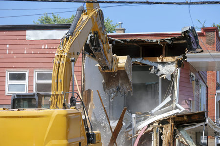 Demolition of an apartment block with an excavator.