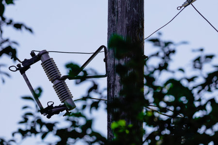 Electricity post with wires and cables in the countryside. Selective focus.